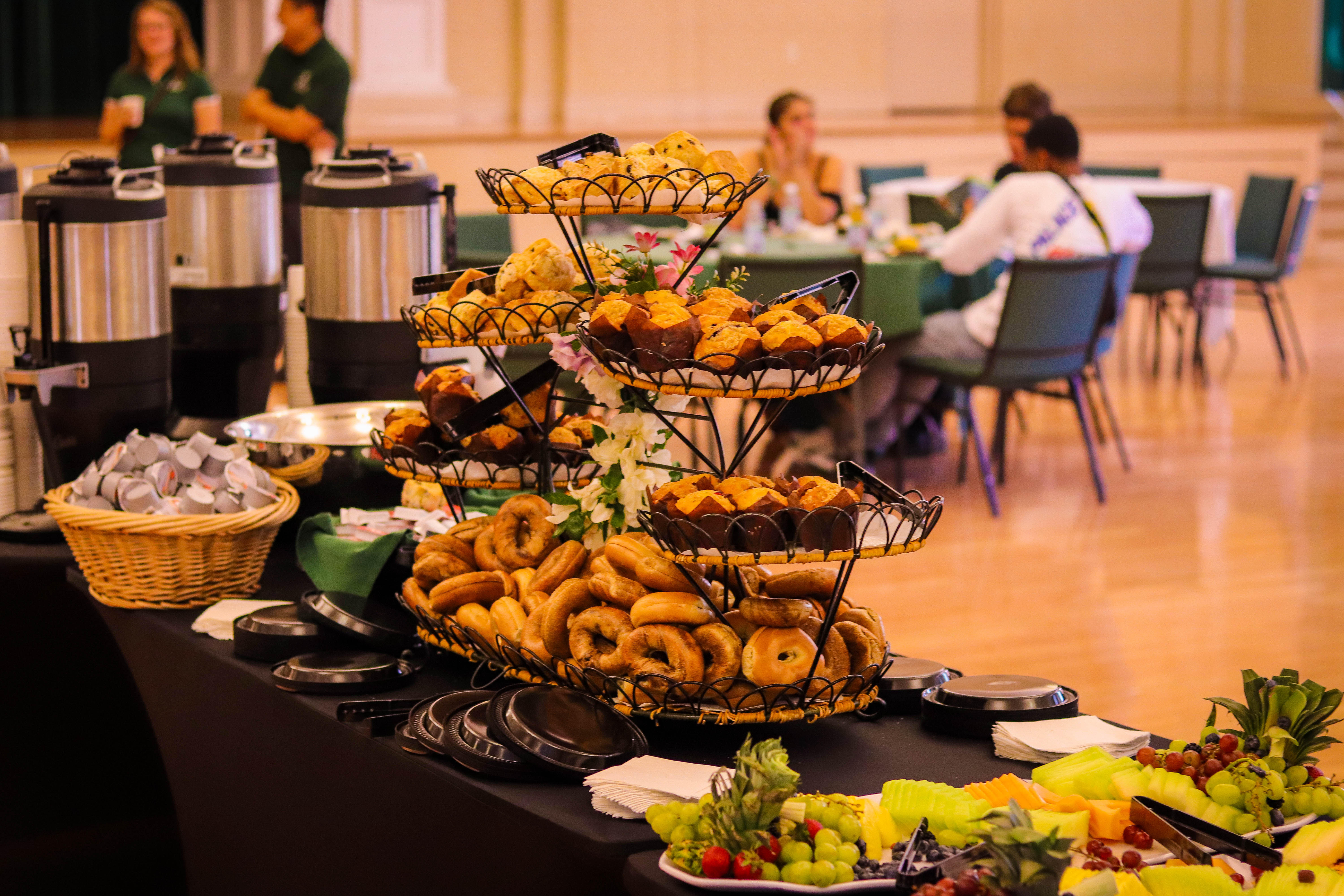 Photo of pastries on table with students in background